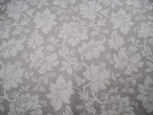 Close-up of MARY GREY fabric by Arte Fresca Outlet, showcasing its detailed floral jacquard pattern in beige on a cool grey background, ideal for curtains or upholstery.