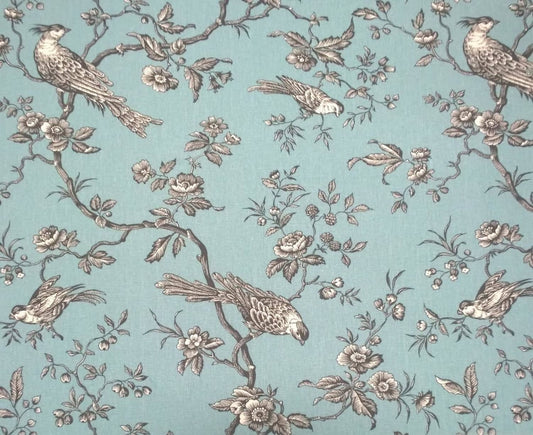 A large view of the Conway Ciel French cotton fabric from Arte Fresca Outlet, featuring a romantic, grey bird and branch pattern on a soft turquoise background.