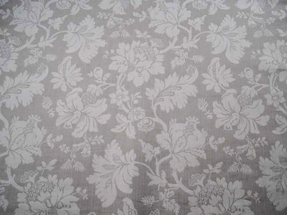 Close-up of MARY GREY fabric by Arte Fresca Outlet, showcasing its detailed floral jacquard pattern in beige on a cool grey background, ideal for curtains or upholstery.