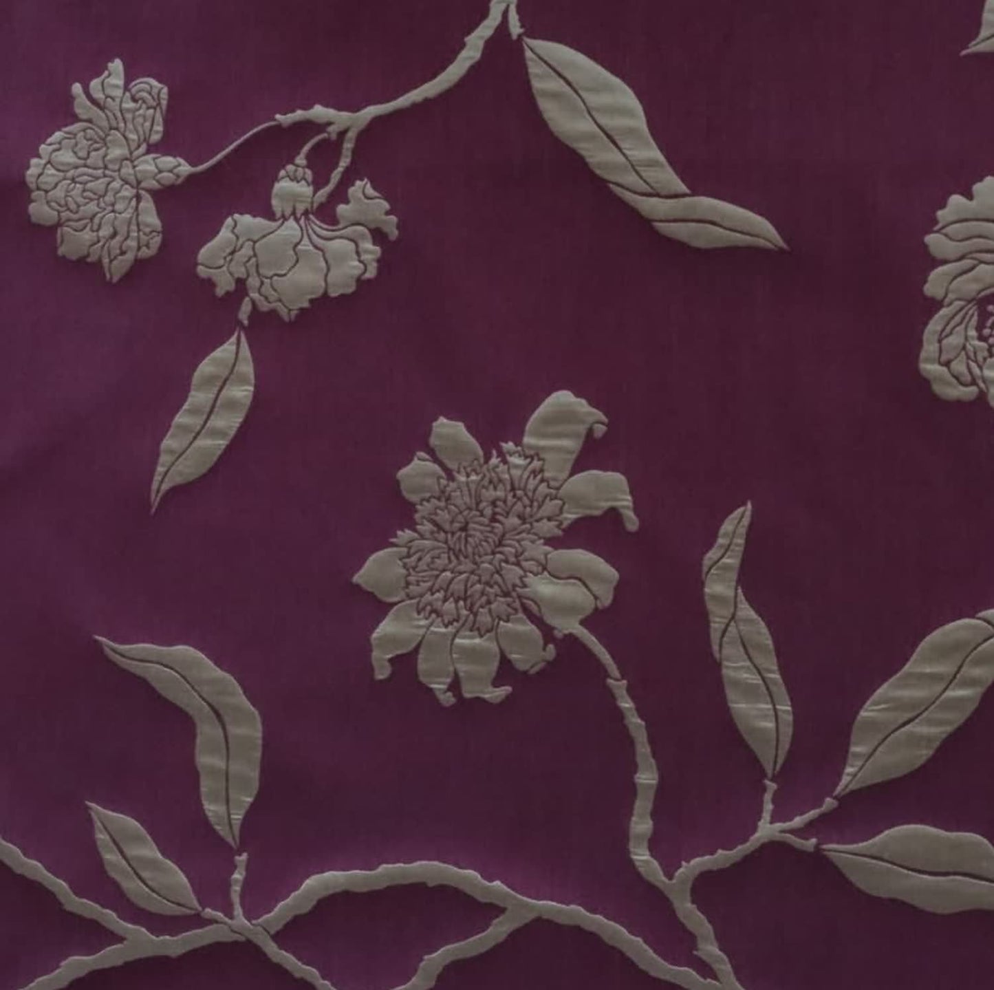 Close-up of PENCARROW DARK RED silk fabric from Arte Fresca Outlet, highlighting the intricate floral pattern, elegant relief-like structure, and soft silken sheen on its dark red base with gold undertones.