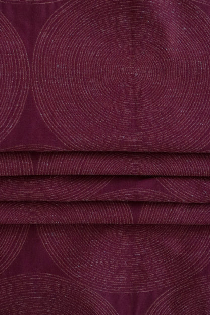 ADAM RED fabric by Arte Fresca Outlet, folded precisely like a Roman blind, highlighting its structured yet adaptable nature, the deep red geometric pattern with relief, and its ability to create sophisticated, well-defined window coverings.