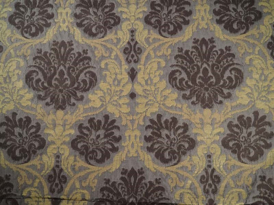 Damask patterned fabric with dark brown floral motifs and gold scrollwork on a muted gray background.