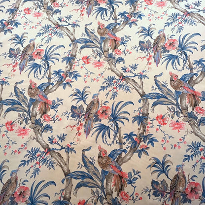 ALLEGRIA BLUE/CREAM fabric coupon by Arte Fresca Outlet, a reduced French 100% cotton remnant. It features a detailed tropical design with a vibrant parrot amidst lush hibiscus blossoms and gentle foliage in soft blue, red, and warm beige tones on a cream background, perfect for small sewing projects.