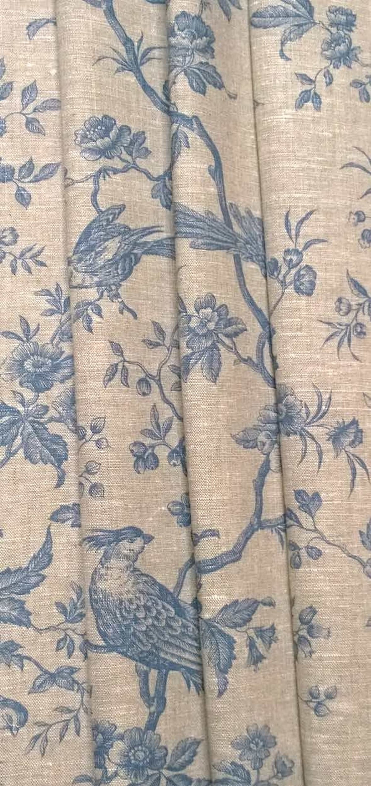 The Conway Lin Blue fabric coupon styled in gentle folds, demonstrating its suitability for curtains and decoration with a charming, timeless feel.