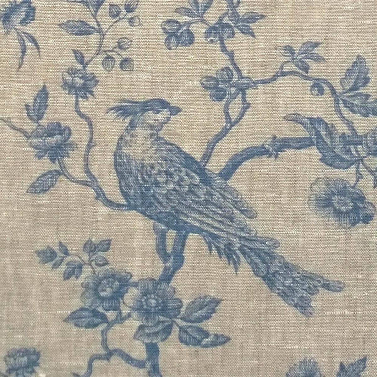 A detailed macro shot of the Arte Fresca Outlet Conway Lin Blue fabric, highlighting the soft blue pattern and the beautiful, rustic texture of the 100% linen.