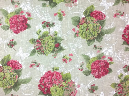 A close-up of a fabric pattern featuring clusters of pink and green hydrangeas with white floral scrollwork on a light beige linen-textured background.