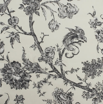 Flat view of printed pure percale cotton fabric featuring a large floral and bird pattern in black on a cream background