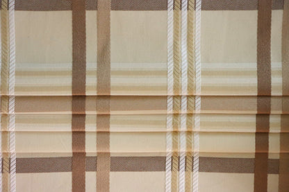 Braxton Check fabric artfully folded like a window blind, displaying its crisp lines and the timeless beige and brown plaid design, perfect for custom blinds from Arte Fresca Outlet.