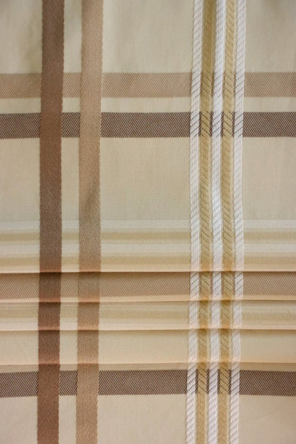 Braxton Check fabric artfully folded like a window blind, displaying its crisp lines and the timeless beige and brown plaid design, perfect for custom blinds from Arte Fresca Outlet.