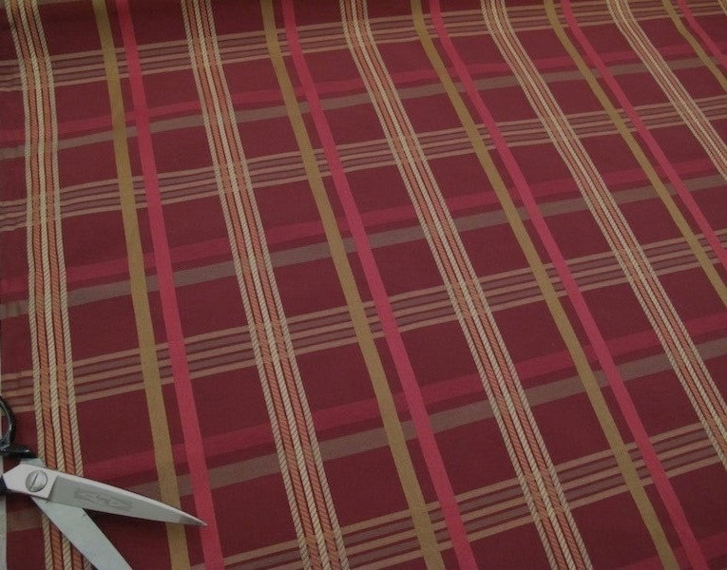 Braxton Check Burgundy fabric by Arte Fresca Outlet, showing a large section of the woven plaid pattern in deep burgundy, gold, beige, and rose tones, highlighting its classic design.