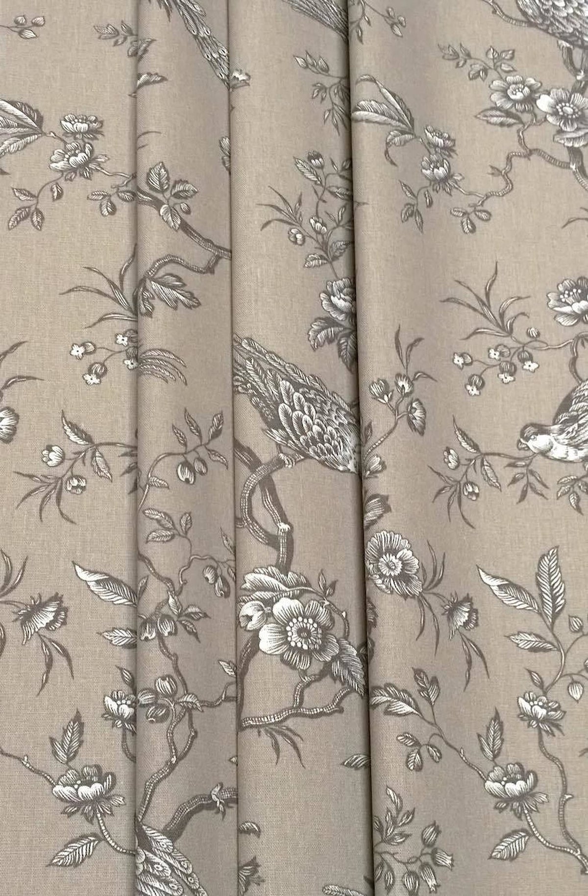 Conway Brown fabric shown in elegant folds, illustrating its use as a curtain material. The romantic bird motif from Arte Fresca Outlet is beautifully displayed in the drapery.