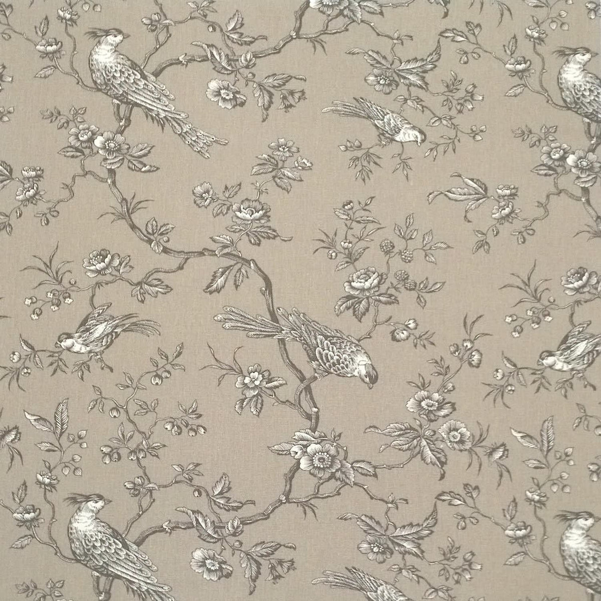 A large view of the Conway Brown French cotton fabric from Arte Fresca Outlet, featuring a romantic, grey bird and branch pattern on a warm beige background.