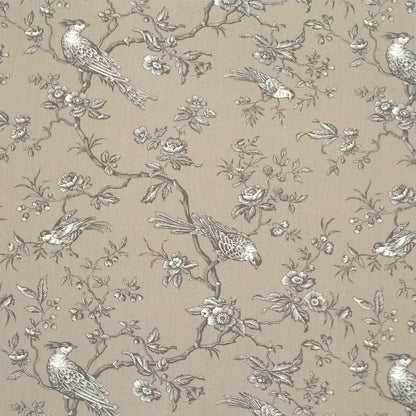 A large view of the Conway Brown French cotton fabric from Arte Fresca Outlet, featuring a romantic, grey bird and branch pattern on a warm beige background.