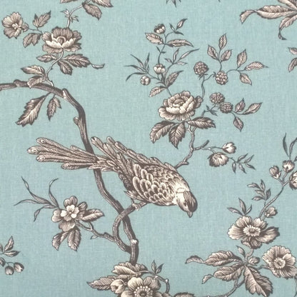 A detailed close-up shot of the Conway Ciel fabric, highlighting the delicate, hand-drawn style of the birds and floral branches in grey on the turquoise background from Arte Fresca Outlet.