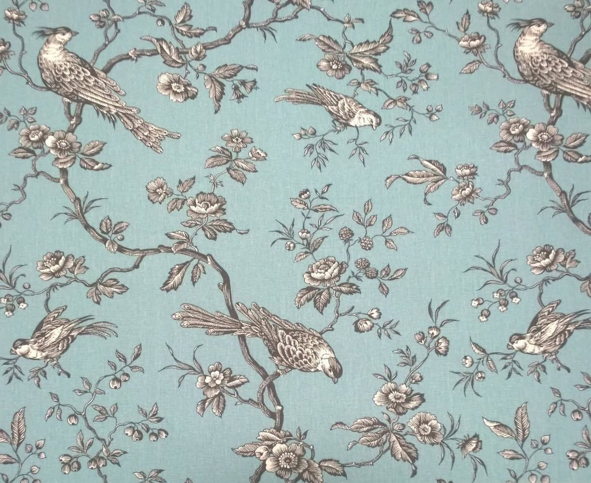 A large view of the Conway Ciel French cotton fabric from Arte Fresca Outlet, featuring a romantic, grey bird and branch pattern on a soft turquoise background.