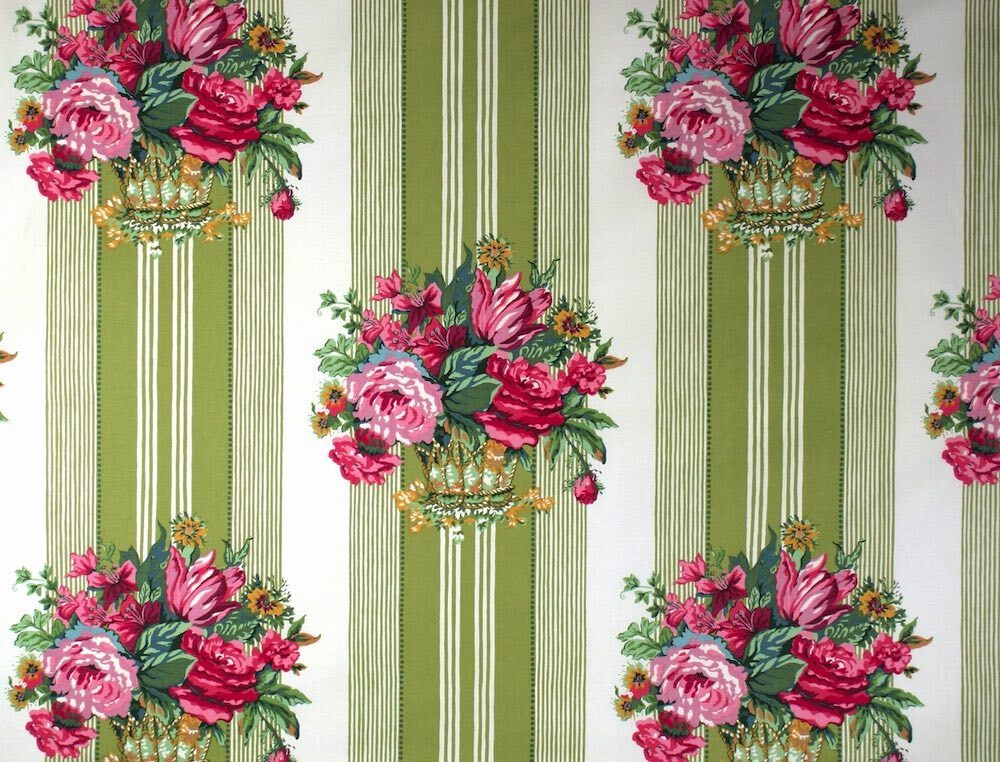 A close-up of a fabric  pattern featuring vertical sage green and cream stripes with ornate bouquets of pink and red flowers, green leaves, and gold accents.