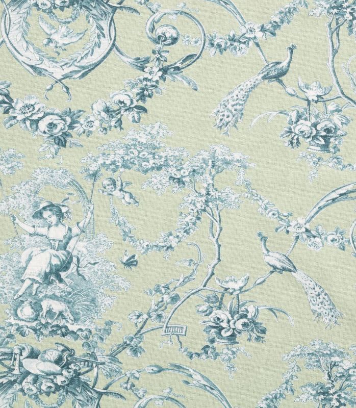 A close-up of a toile patterned fabric featuring a light sage green background with a dusty blue print of peacocks, flowers, cherubs, and classical decorative motifs.