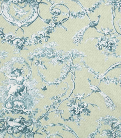 A close-up of a toile patterned fabric featuring a light sage green background with a dusty blue print of peacocks, flowers, cherubs, and classical decorative motifs.