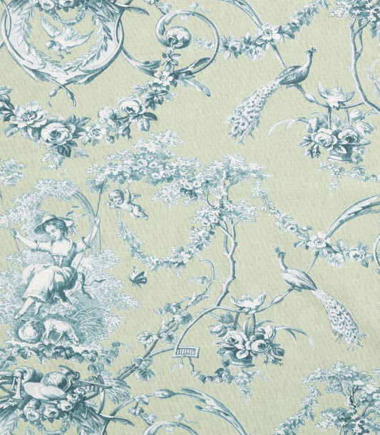 A close-up of a toile patterned fabric featuring a light sage green background with a dusty blue print of peacocks, flowers, cherubs, and classical decorative motifs.