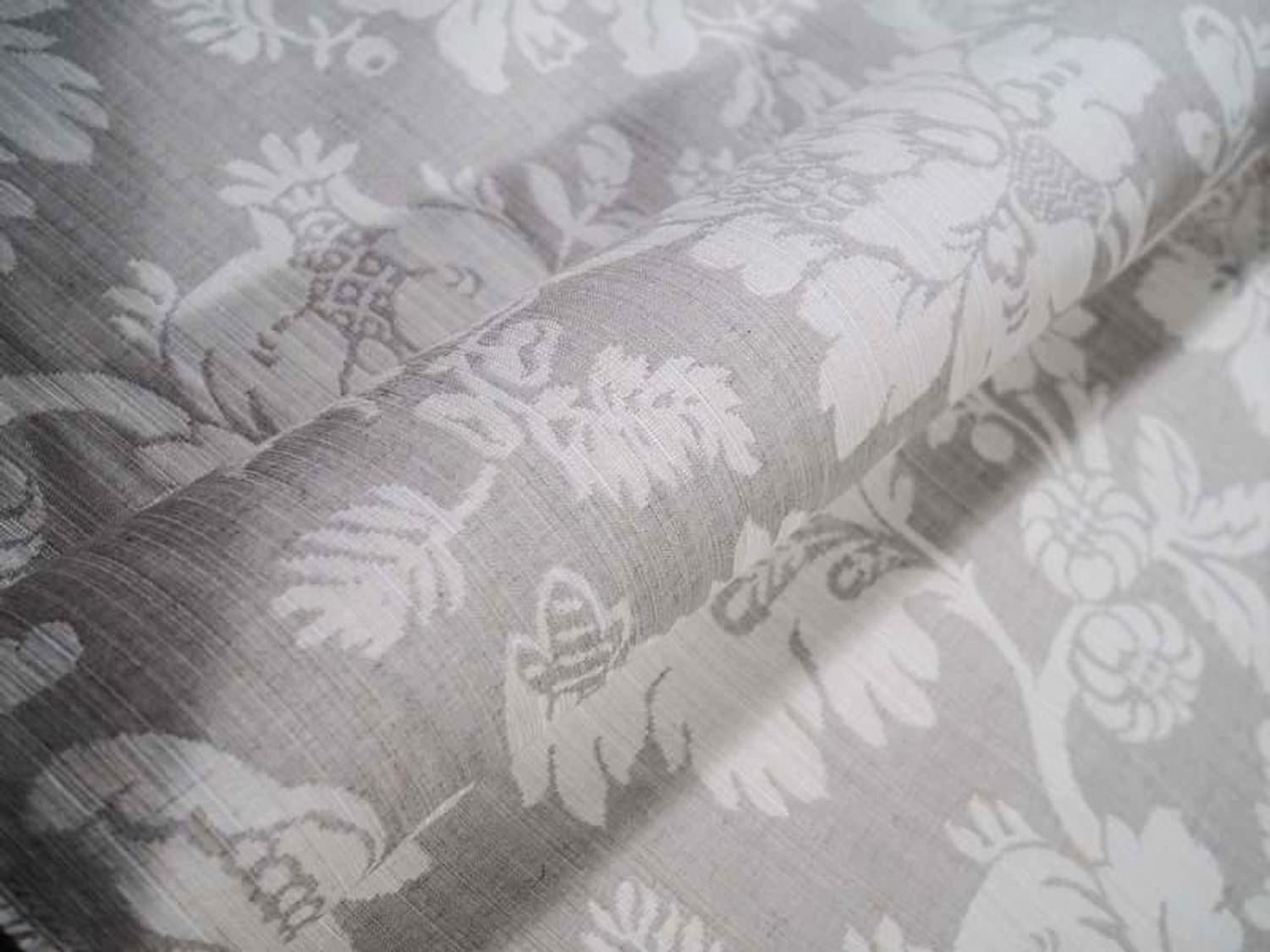 Detailed close-up of MARY GREY fabric by Arte Fresca Outlet, highlighting the intricate woven floral motifs and subtle texture of this elegant grey and beige jacquard.