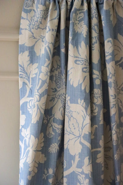 Mary Light Blue jacquard fabric by Arte Fresca Outlet elegantly folded like a curtain, demonstrating its beautiful drape and suitability for sophisticated window treatments.