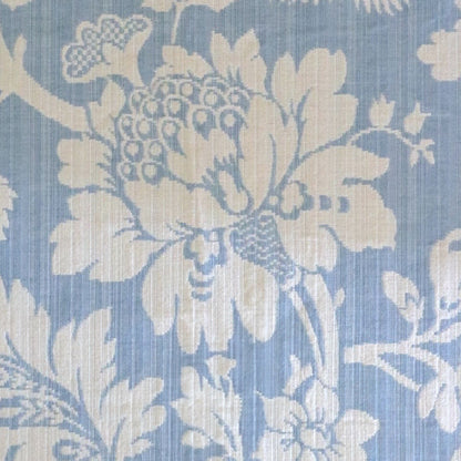Mary Light Blue jacquard fabric by Arte Fresca Outlet, featuring a large view of the delicate white floral pattern on a powder blue background, ideal for elegant home decor.