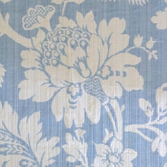 Mary Light Blue jacquard fabric by Arte Fresca Outlet, featuring a large view of the delicate white floral pattern on a powder blue background, ideal for elegant home decor.