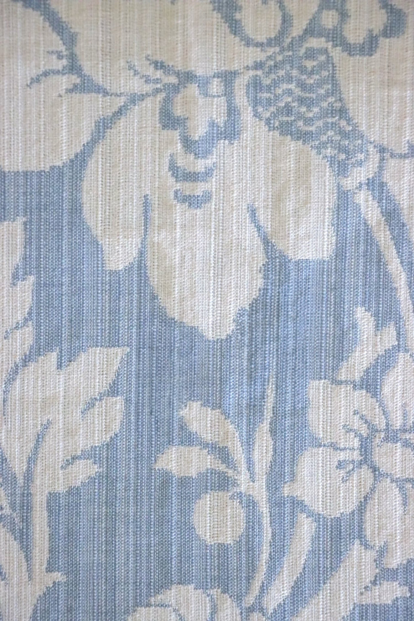 Close-up of Mary Light Blue jacquard fabric by Arte Fresca Outlet, highlighting the intricate white floral motif and luxurious texture on a soft powder blue background.