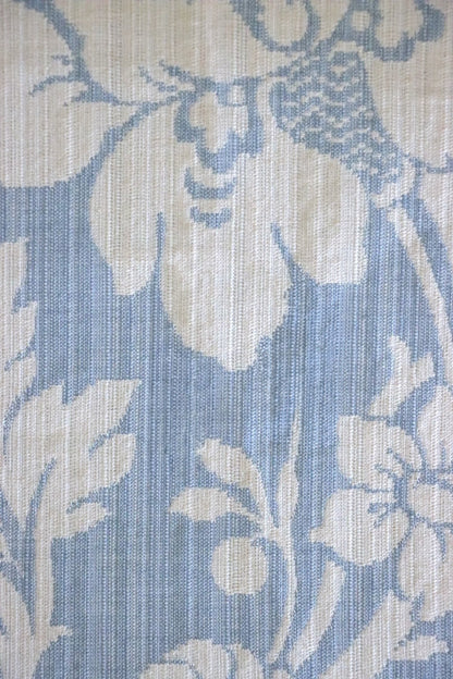 Close-up of Mary Light Blue jacquard fabric by Arte Fresca Outlet, highlighting the intricate white floral motif and luxurious texture on a soft powder blue background.