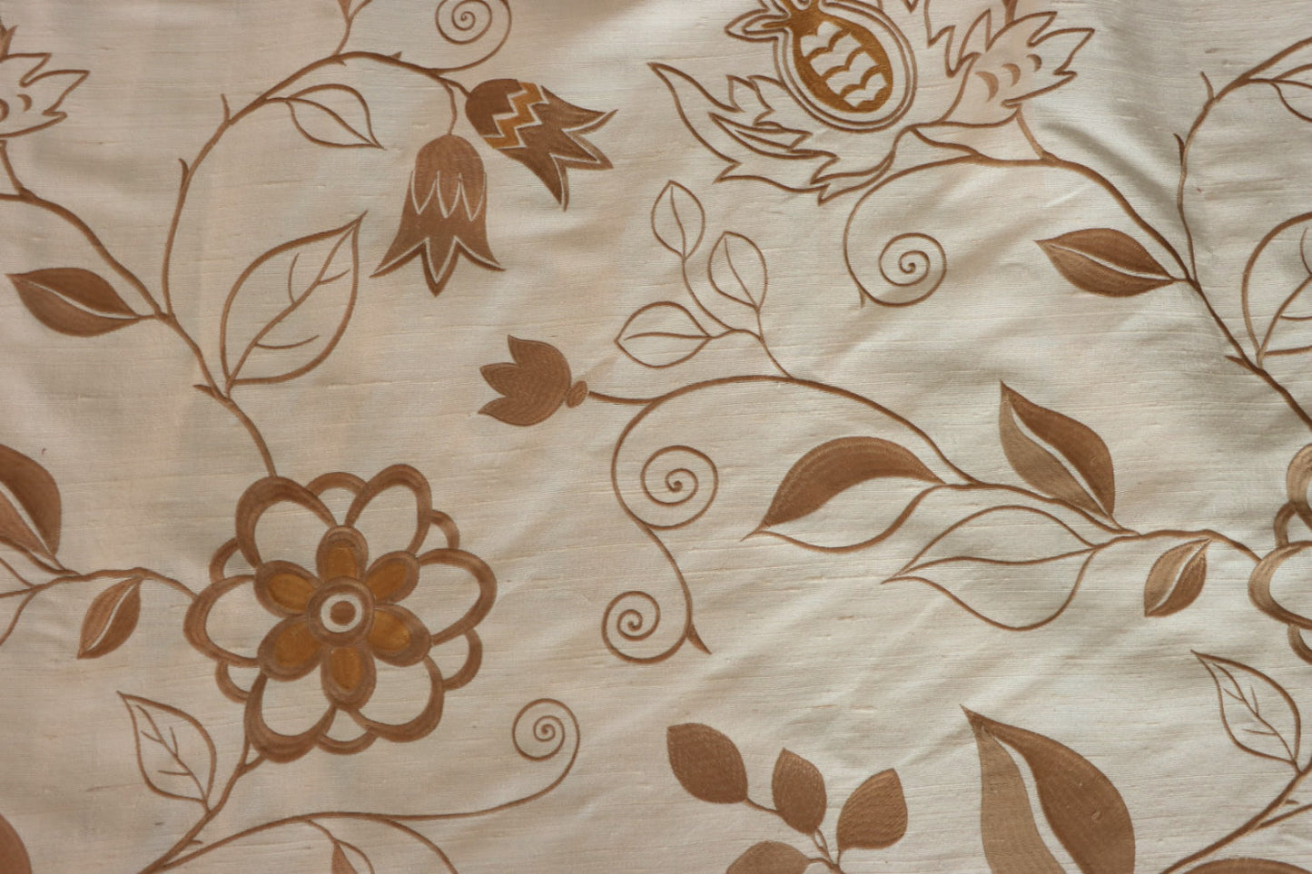 MOREEN CAMEL silk fabric by Arte Fresca Outlet, a full view displaying its delicate embroidered floral pattern in harmonious brown tones on a soft camel background, highlighting the fabric's exquisite texture and subtle sheen.
