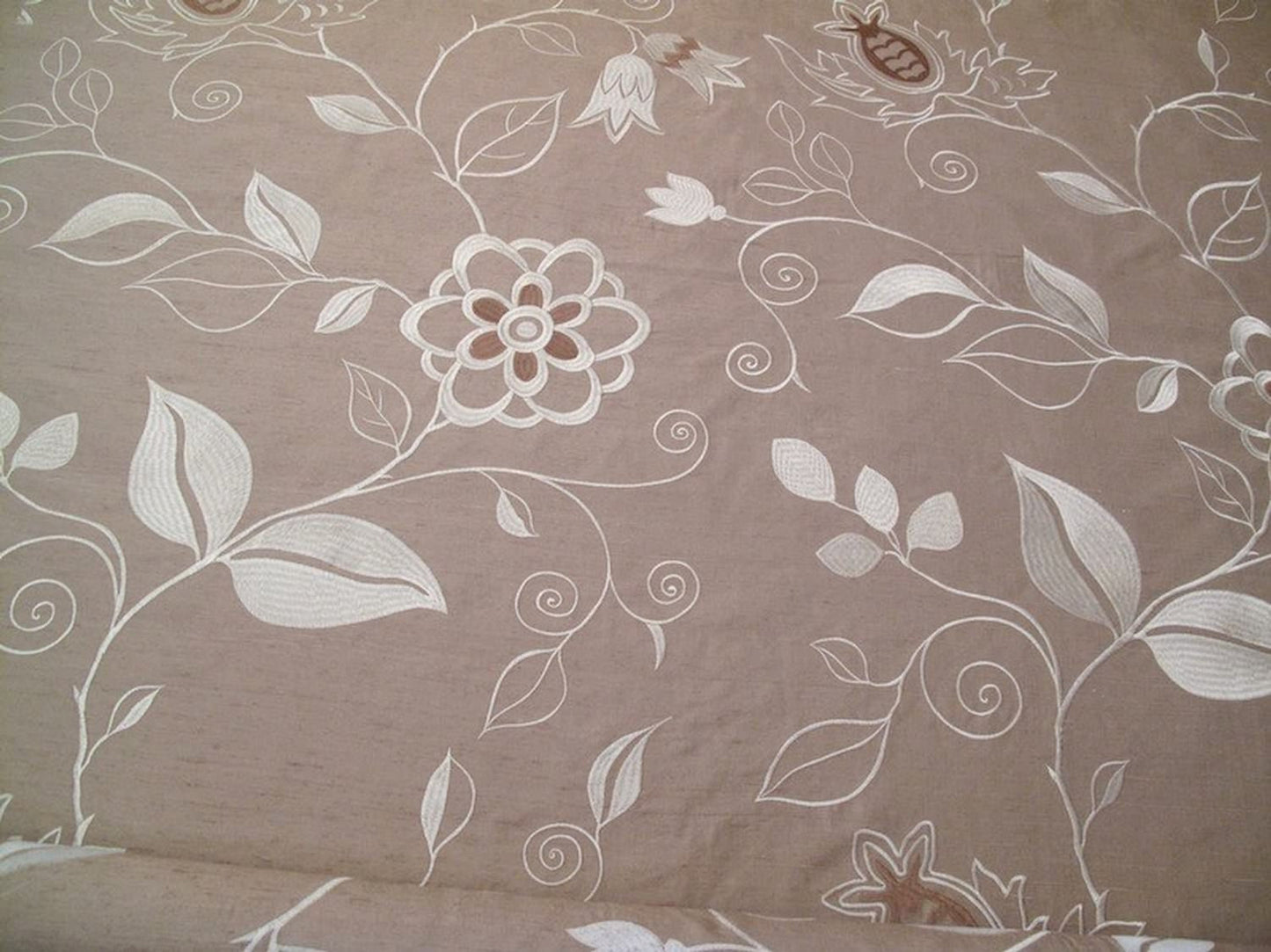 MOREEN LINEN embroidered silk fabric by Arte Fresca Outlet, a full view displaying its large floral embroidery in cream, ivory, and brown on a muted gold-beige silk ground, highlighting its elegant texture.