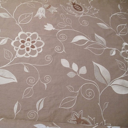MOREEN LINEN embroidered silk fabric by Arte Fresca Outlet, a full view displaying its large floral embroidery in cream, ivory, and brown on a muted gold-beige silk ground, highlighting its elegant texture.