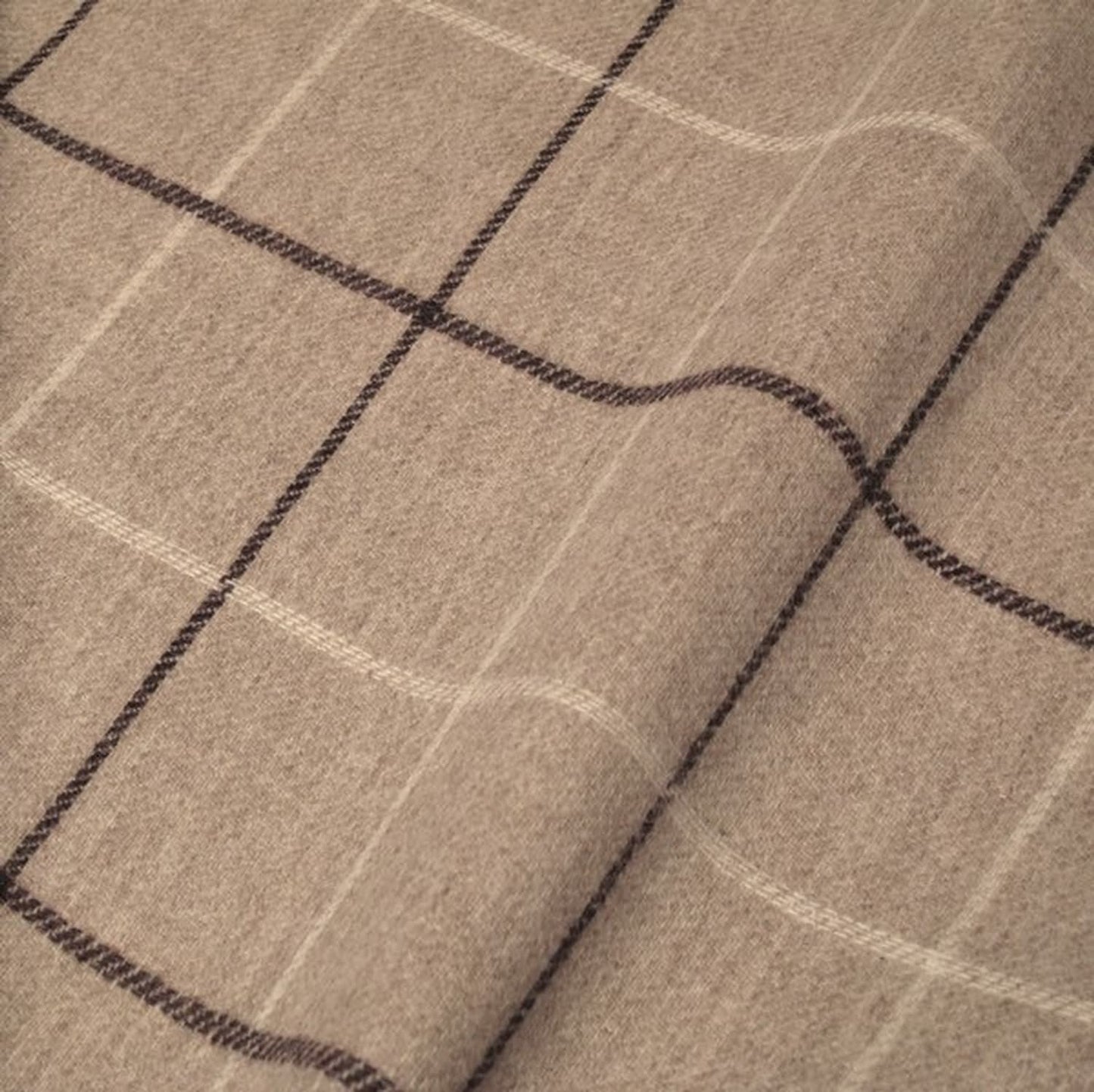 Close-up of OXFORD CHECK PLUM fabric from Arte Fresca Outlet, showcasing the finely woven 100% wool texture and the classic check pattern with subtle plum and cream white lines on a warm light beige background, emphasizing its soft feel.