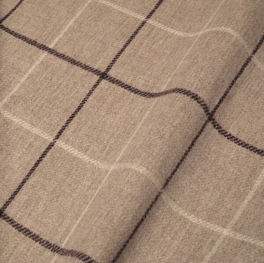 Close-up of OXFORD CHECK PLUM fabric from Arte Fresca Outlet, showcasing the finely woven 100% wool texture and the classic check pattern with subtle plum and cream white lines on a warm light beige background, emphasizing its soft feel.