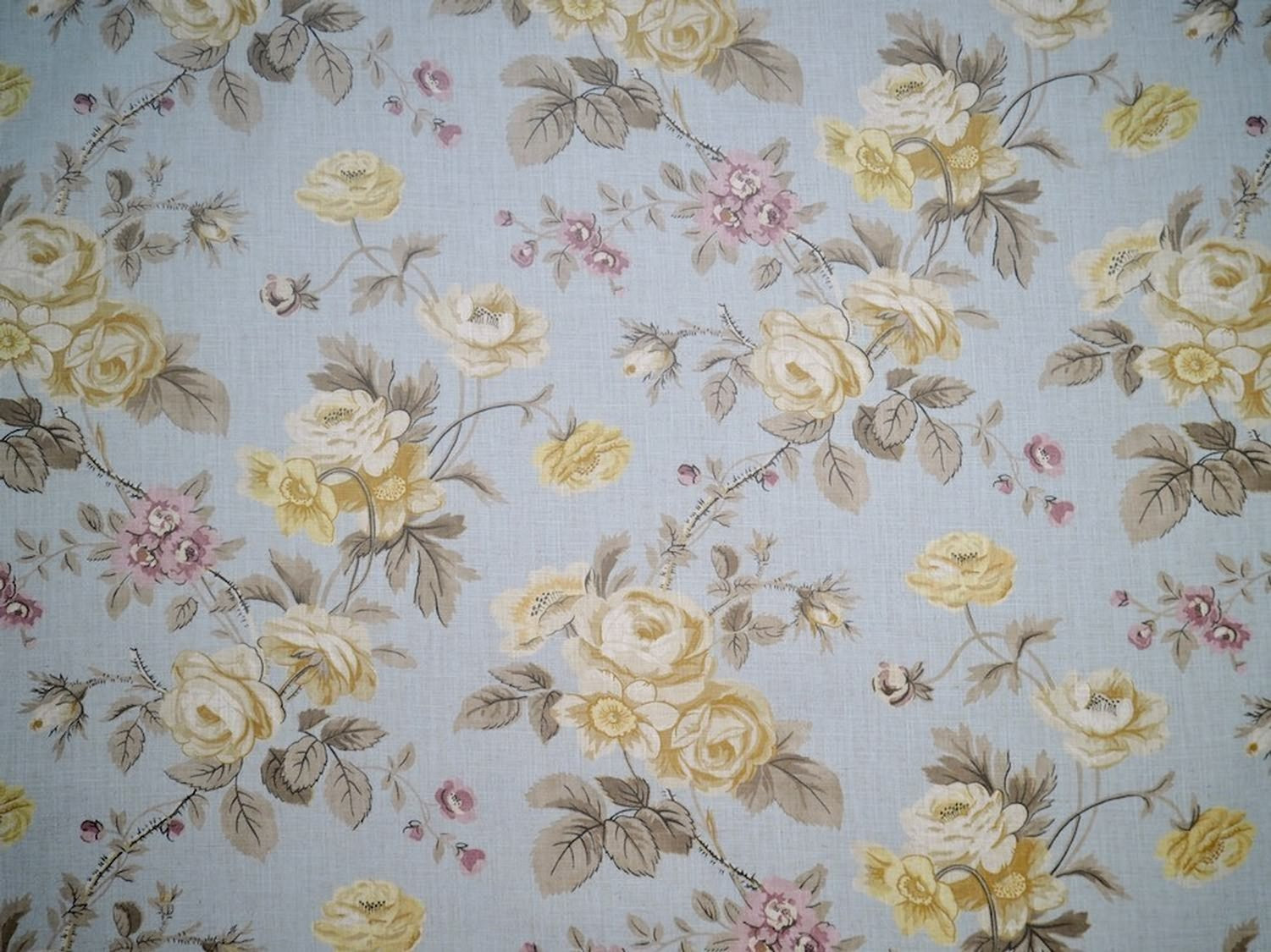 PHILIPPA PALE BLUE fabric by Arte Fresca Outlet, a full view displaying its romantic floral rose pattern in creams, pinks, and muted greens on a pale blue linen blend, highlighting its natural texture.