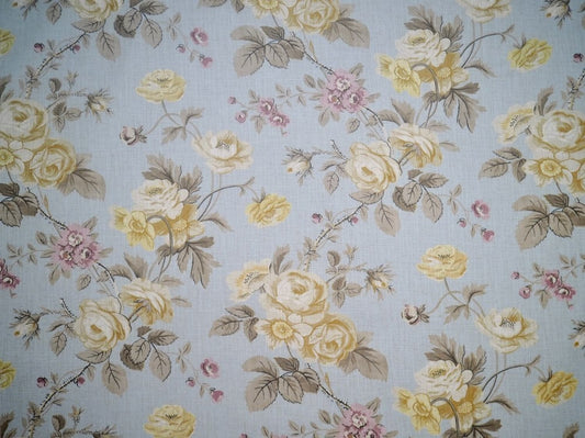 PHILIPPA PALE BLUE fabric by Arte Fresca Outlet, a full view displaying its romantic floral rose pattern in creams, pinks, and muted greens on a pale blue linen blend, highlighting its natural texture.