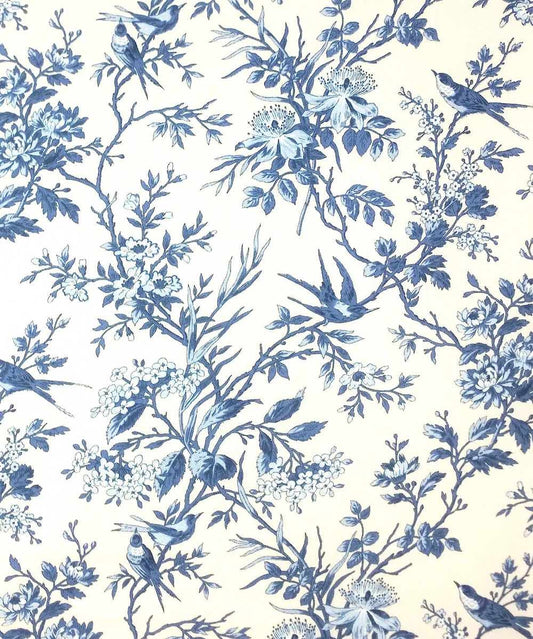 Blue and white floral toile pattern with birds and branches, shown as a close-up of fabric or wallpaper print.
