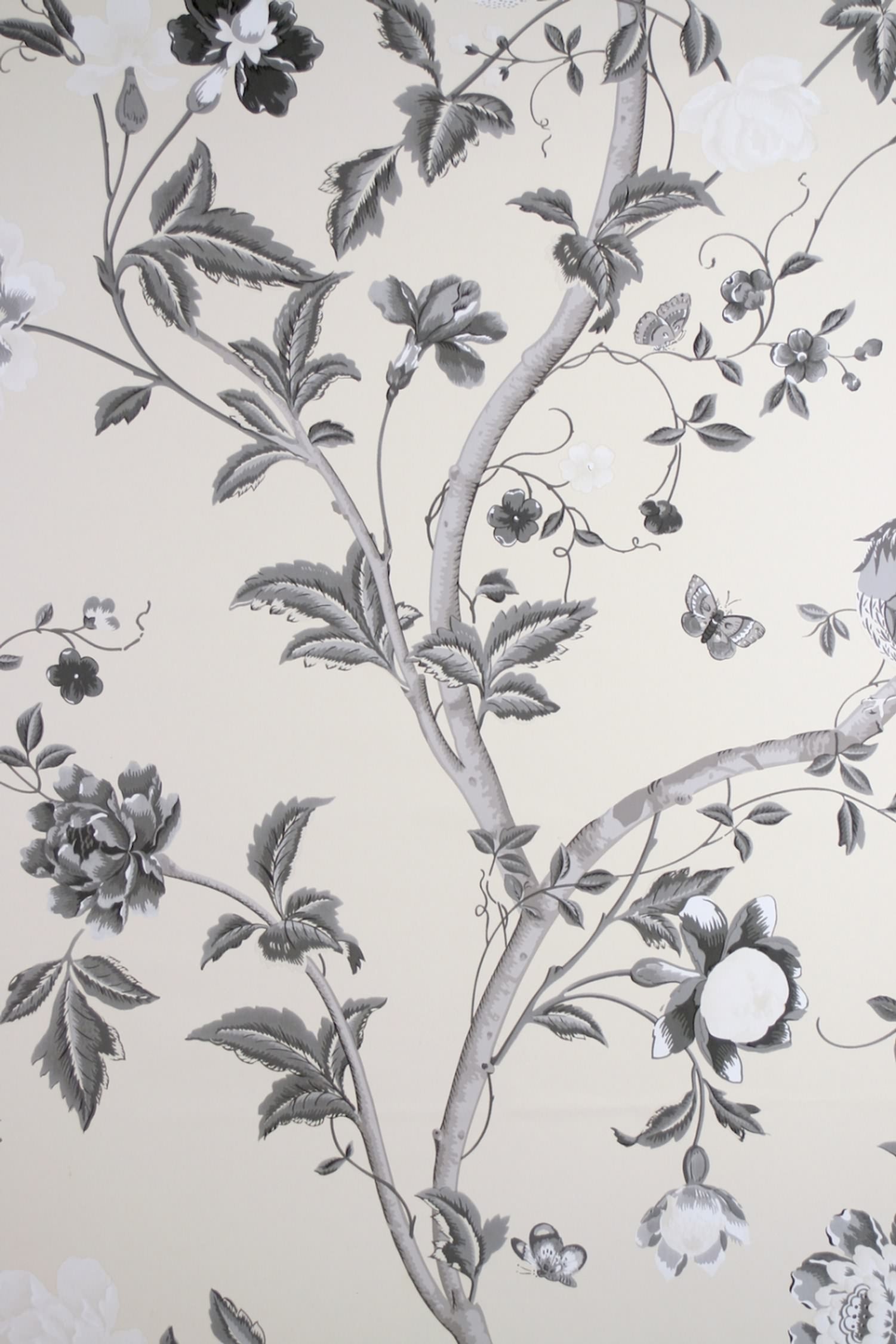 SUMMER PALACE CHARCOAL wallpaper by Laura Ashley at Arte Fresca Outlet. This exquisite paper wallcovering features a detailed floral and botanical pattern with graceful plant tendrils, large blossoms, leaves, butterflies, and a delicate bird, all rendered in an elegant black-white-grey scale on a warm, cream-colored background, embodying classic elegance and romantic Asian poetry.