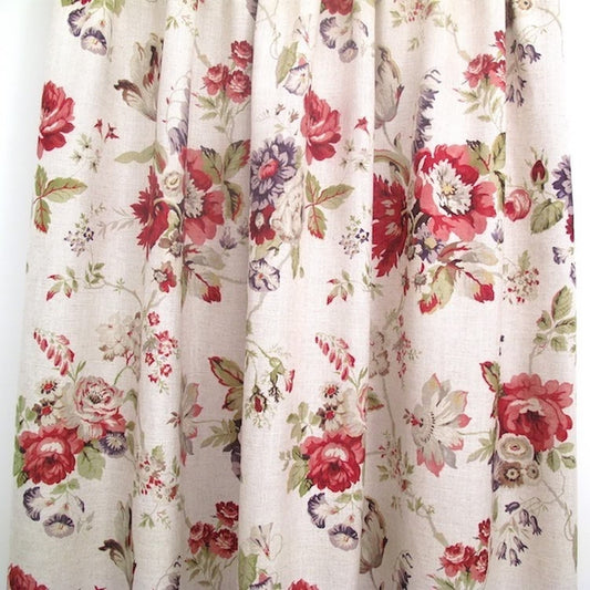 "Victoria Multi/Green fabric from Arte Fresca Outlet, folded like a curtain to demonstrate its natural drape and the full effect of its opulent floral pattern, perfect for elegant window treatments."