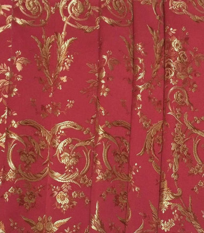 A reduced-price fabric coupon of the VILLA BORGHESE fabric in red and gold, draped in elegant folds like a luxurious curtain. The image shows the opulent, rococo-inspired pattern and the heavy, rich drape of the woven fabric. Ideal for home decor projects. Available at Arte Fresca Outlet.