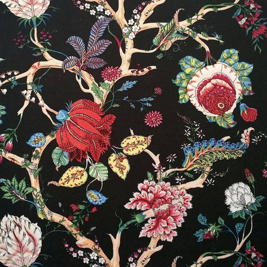 Villars Multi Black fabric coupon by Arte Fresca Outlet, showing a large view of its opulent botanical pattern. This printed 100% cotton fabric features lush, imaginative blossoms in vibrant red, fuchsia, green, yellow, and blue on intricate branches against a deep black background, displaying a smooth texture.
