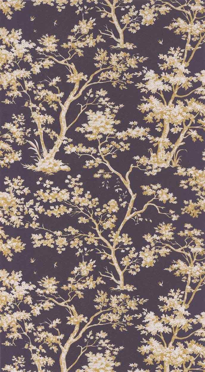 A close-up of a repeating floral toile pattern with pale yellow blossoms and branches on a dark plum-purple background.