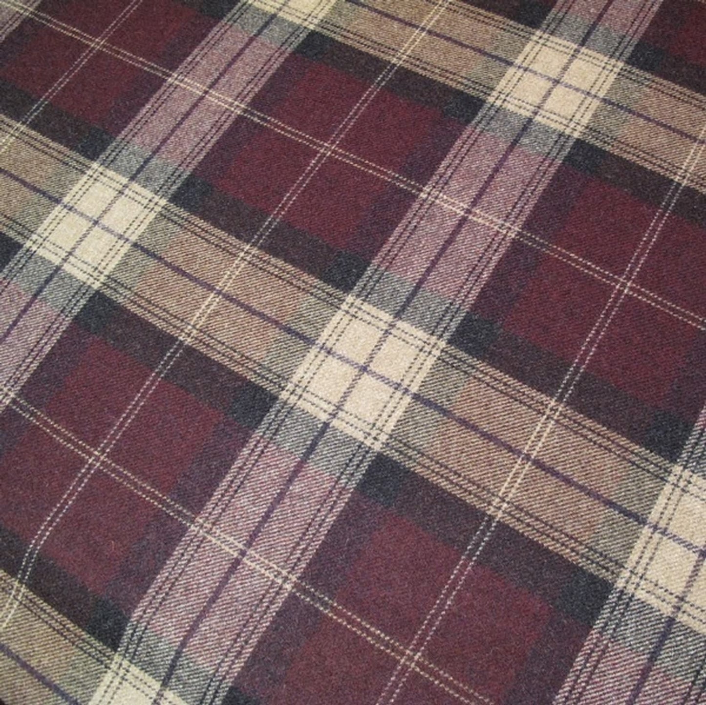 Close-up of YORK PLAID PLUM fabric from Arte Fresca Outlet, showcasing its robust 100% wool weave and authentic matte texture. The precise crossing lines of the classic plaid pattern in deep plum-red/bordeaux, beige, and fine accent colors are visible, highlighting its quality and durability for heavy-duty upholstery.